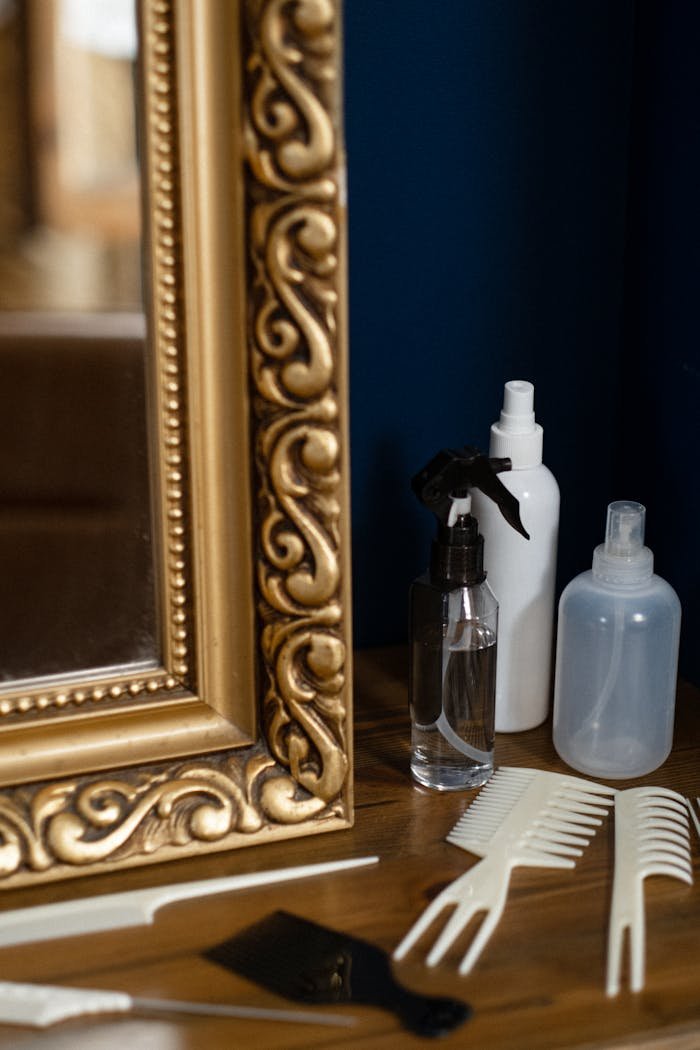 why-choose-us Golden ornate mirror and hair styling tools creating a chic salon atmosphere.