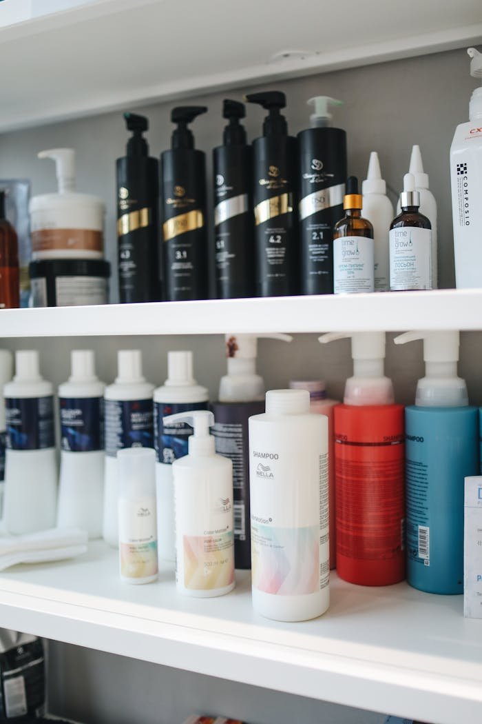 ours-journey Variety of shampoos and conditioners displayed neatly on a shelf, ideal for beauty and haircare themes.