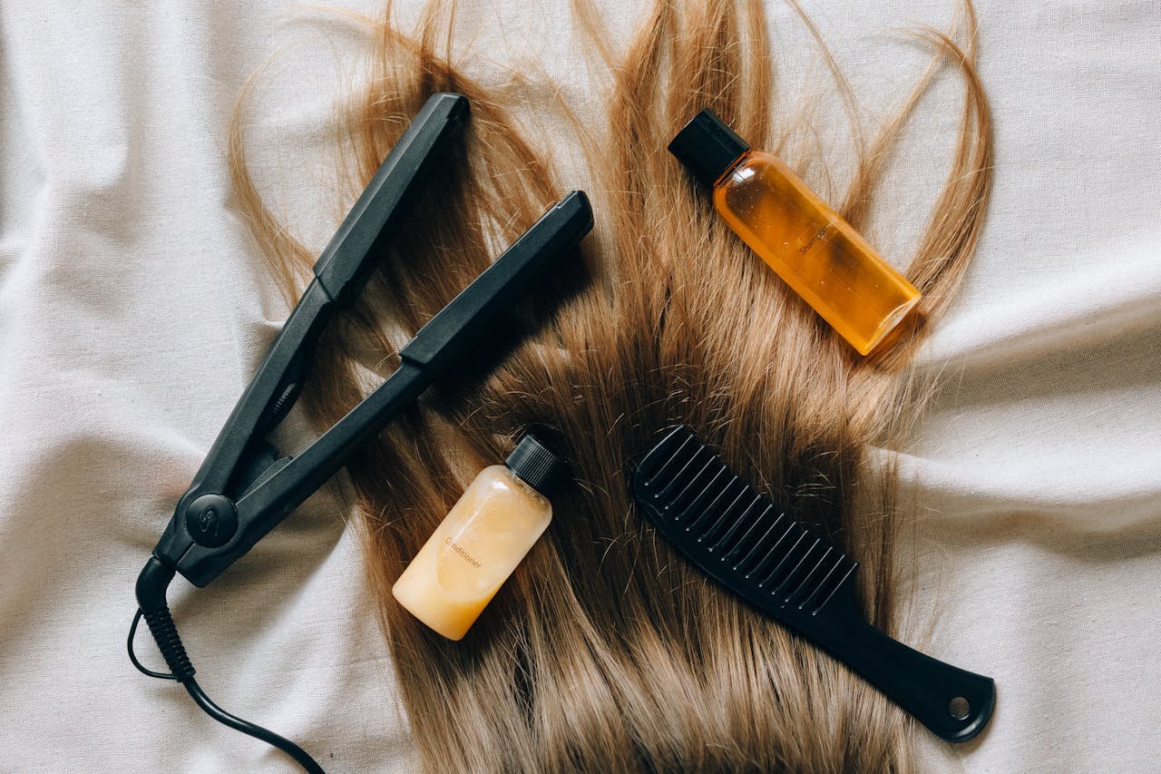 hero-img-01 Aesthetic flat lay of hair products and tools for styling and grooming.